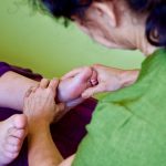 Someone receiving reflexology.