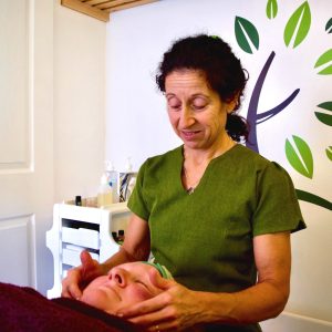 a women relaxing and smiling whilst having a relaxing massage